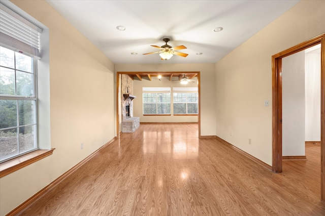 unfurnished living room with light hardwood / wood-style floors and ceiling fan