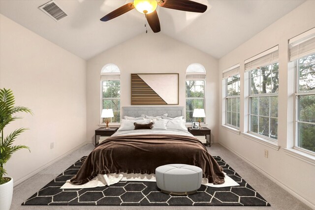 carpeted empty room featuring vaulted ceiling with beams, a healthy amount of sunlight, and ceiling fan