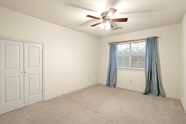 empty room with light carpet and ceiling fan