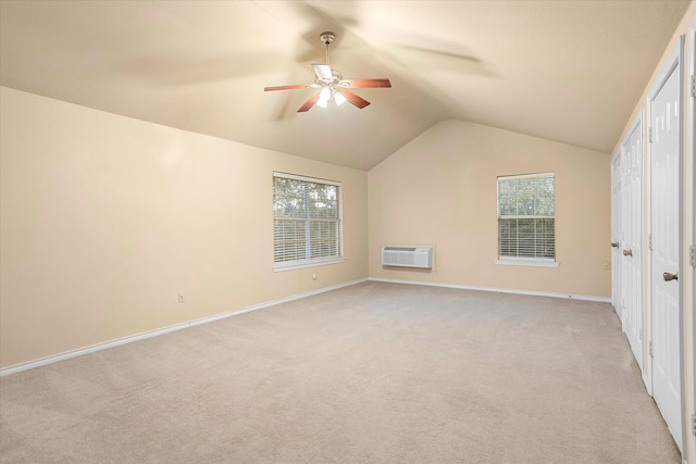 bonus room featuring vaulted ceiling, light carpet, a wall mounted air conditioner, and ceiling fan