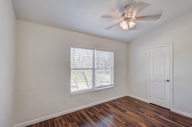 spare room featuring lofted ceiling, ceiling fan, and dark hardwood / wood-style flooring