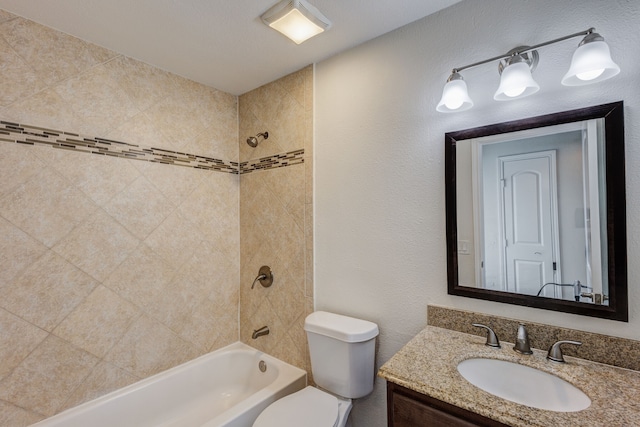 full bathroom featuring vanity, toilet, and tiled shower / bath combo