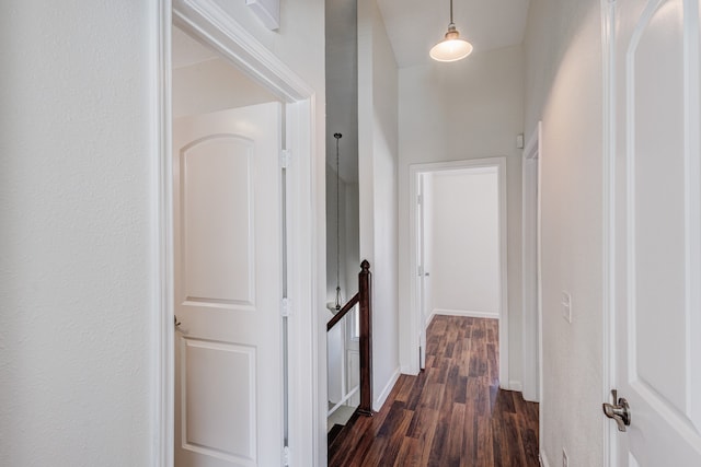 corridor with dark hardwood / wood-style flooring