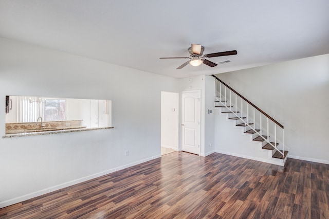 unfurnished living room with sink, dark wood-type flooring, and ceiling fan