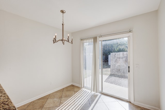 entryway featuring light tile patterned flooring and an inviting chandelier