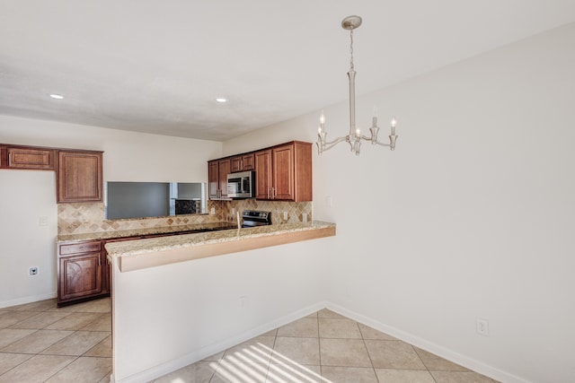 kitchen with kitchen peninsula, tasteful backsplash, light tile patterned floors, appliances with stainless steel finishes, and pendant lighting