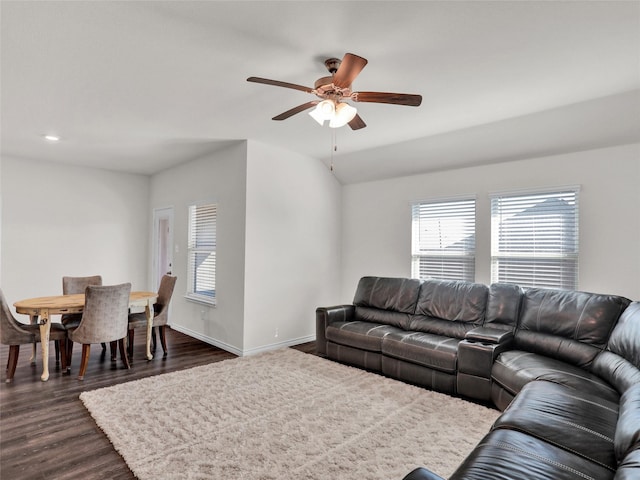 living room featuring dark wood-type flooring, ceiling fan, and lofted ceiling