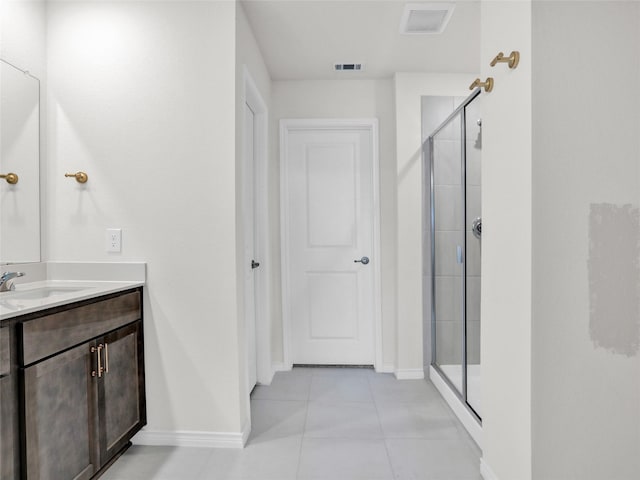 bathroom with vanity, tile patterned flooring, and a shower with shower door