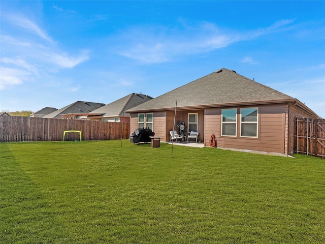 back of house with a patio and a yard