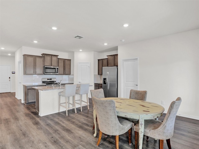 dining space featuring sink and dark hardwood / wood-style flooring