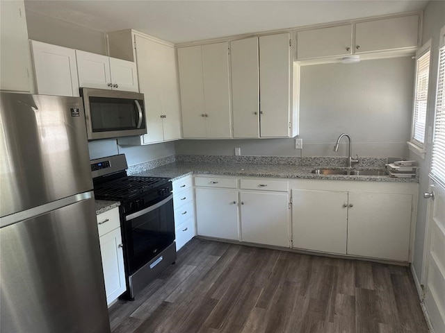 kitchen with sink, dark wood-type flooring, white cabinets, and stainless steel appliances