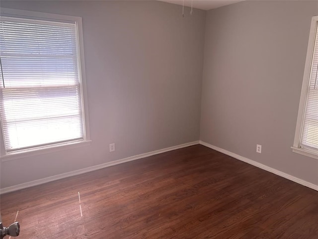 empty room with dark wood-type flooring