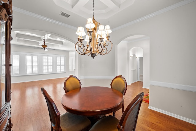 dining space with coffered ceiling, ceiling fan with notable chandelier, crown molding, light hardwood / wood-style flooring, and beam ceiling