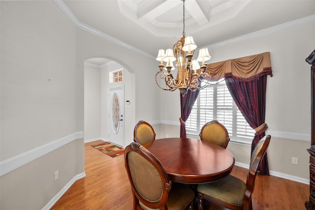 dining room featuring coffered ceiling, ornamental molding, beam ceiling, light hardwood / wood-style floors, and a chandelier