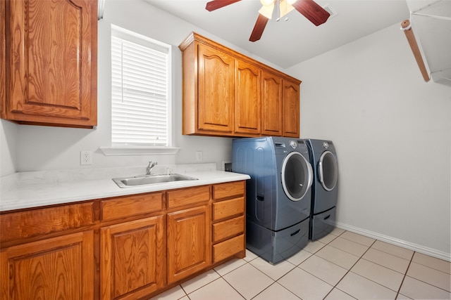 washroom featuring cabinets, ceiling fan, sink, washing machine and dryer, and light tile patterned flooring