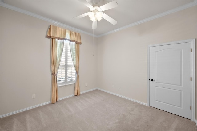 empty room featuring light carpet and crown molding