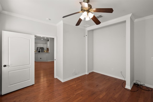 unfurnished room with crown molding, ceiling fan, and dark wood-type flooring