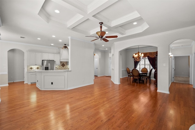 unfurnished living room featuring light wood-type flooring, coffered ceiling, ceiling fan with notable chandelier, crown molding, and beamed ceiling