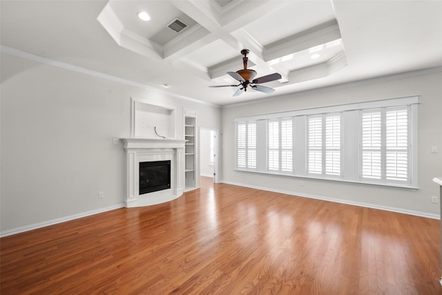 unfurnished living room featuring a wealth of natural light, light hardwood / wood-style flooring, crown molding, and coffered ceiling