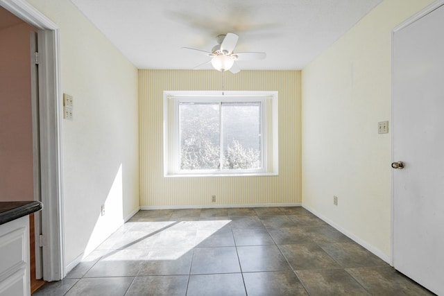 unfurnished dining area with ceiling fan and tile patterned floors