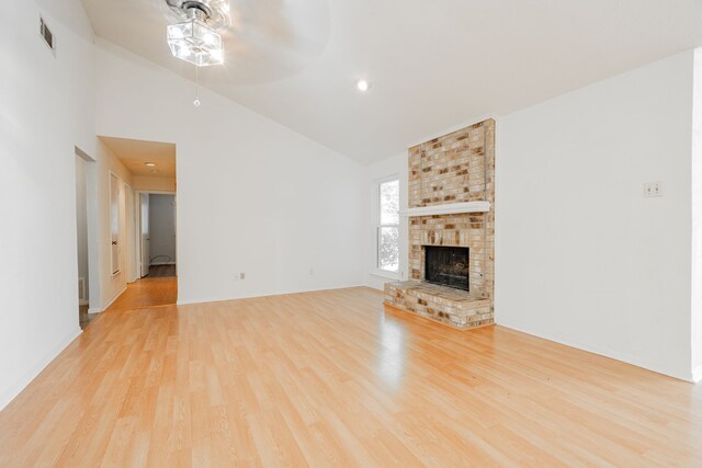 empty room with light hardwood / wood-style flooring and vaulted ceiling with skylight