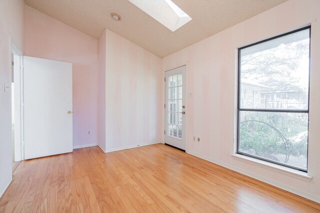 empty room with ceiling fan, a textured ceiling, light carpet, and crown molding