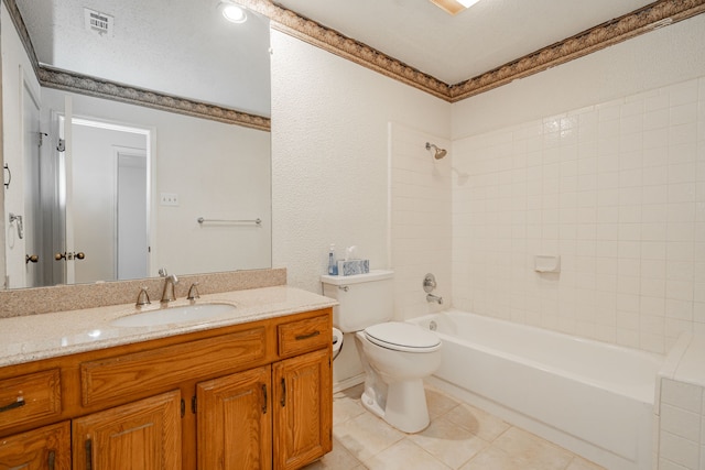 full bathroom featuring vanity, tile patterned floors, toilet, and tiled shower / bath combo