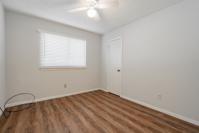 spare room featuring a textured ceiling, dark hardwood / wood-style flooring, and ceiling fan