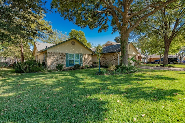 single story home with brick siding and a front yard