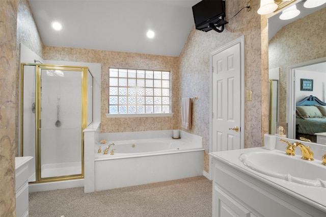 bathroom featuring vanity, vaulted ceiling, and separate shower and tub