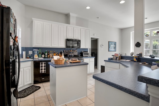 kitchen with black appliances, a center island, white cabinets, and beverage cooler