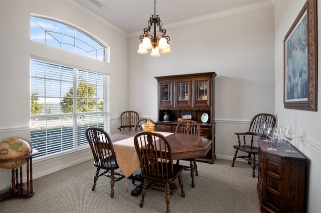 carpeted dining area featuring an inviting chandelier and ornamental molding