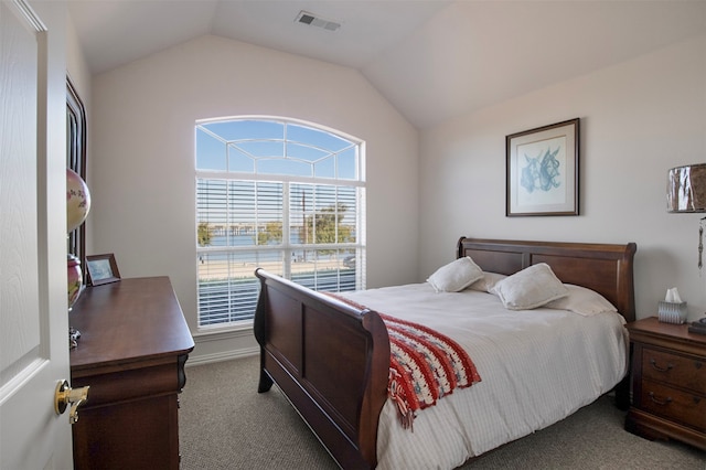 bedroom with vaulted ceiling and carpet flooring