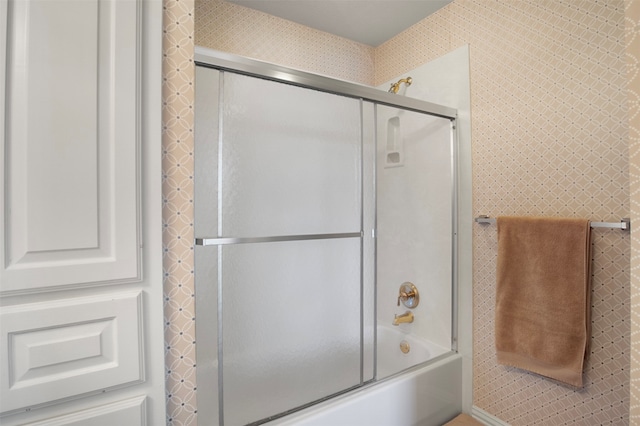 bathroom with shower / bath combination with glass door