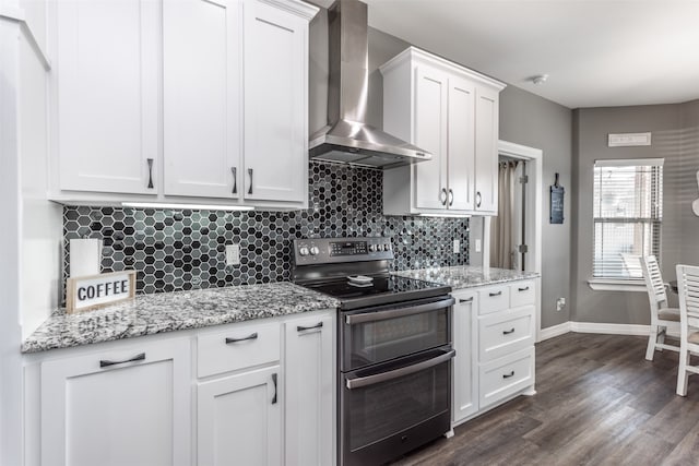 kitchen featuring wall chimney range hood, backsplash, stainless steel electric range, white cabinetry, and dark hardwood / wood-style flooring