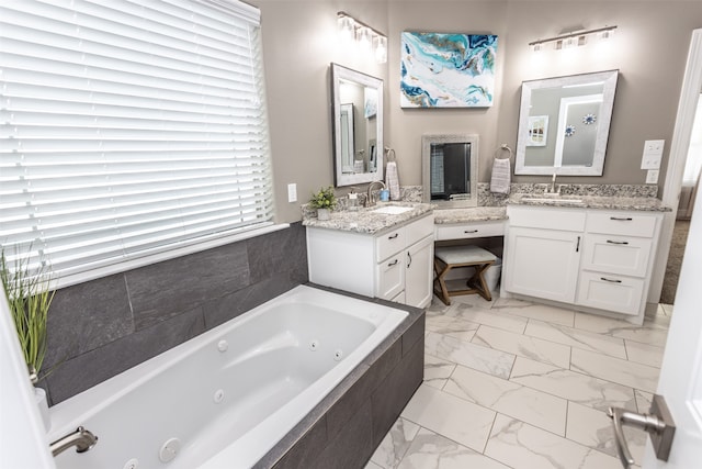 bathroom featuring vanity and a relaxing tiled tub