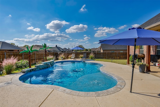 view of swimming pool featuring pool water feature and a patio