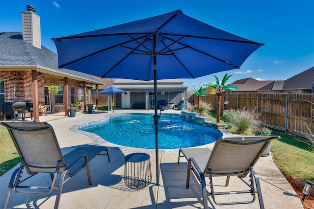 view of pool with a patio area and pool water feature