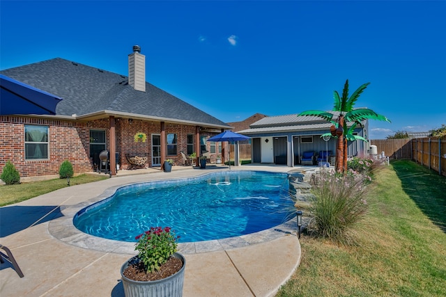 view of pool with a yard and a patio