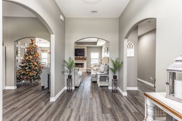 foyer featuring dark hardwood / wood-style floors and a large fireplace