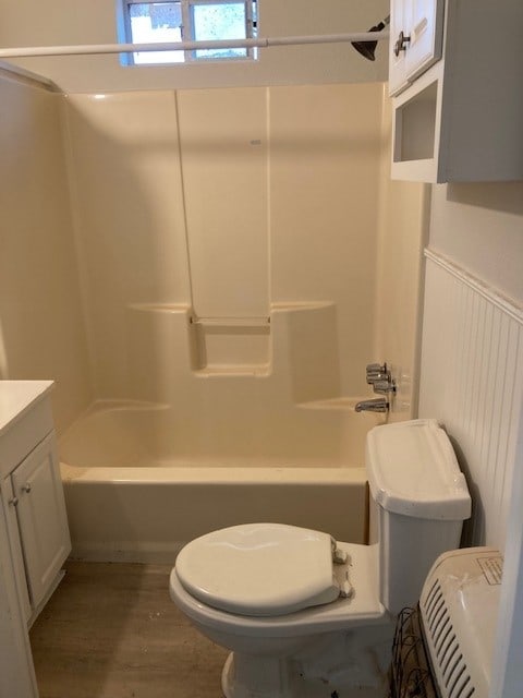 full bathroom featuring hardwood / wood-style floors, vanity, toilet, and shower / bathtub combination