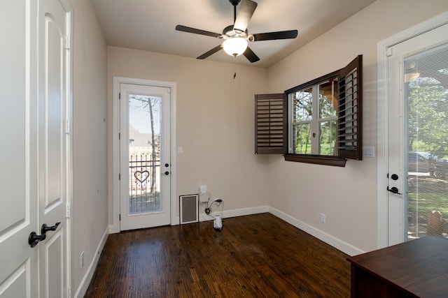 entryway with dark wood-type flooring, ceiling fan, and a wealth of natural light