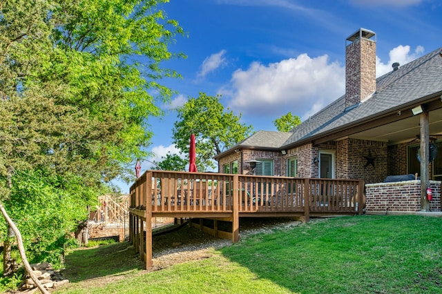 wooden terrace featuring a lawn