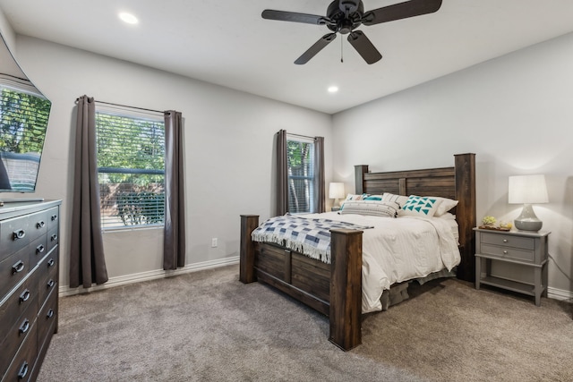 bedroom with multiple windows, light colored carpet, and ceiling fan