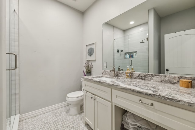 bathroom with vanity, toilet, tile patterned floors, and a shower with shower door