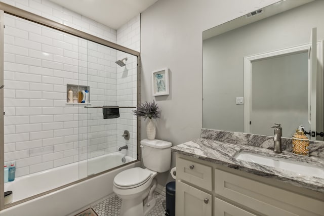 full bathroom with vanity, toilet, tile patterned floors, and enclosed tub / shower combo