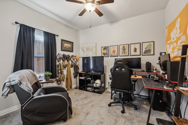 carpeted office featuring ceiling fan