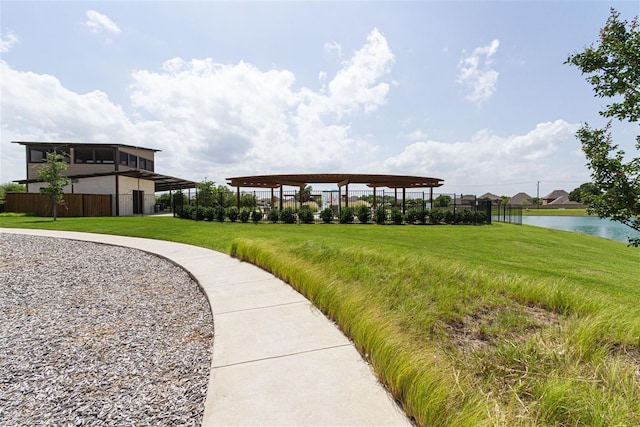 surrounding community with a yard and a water view