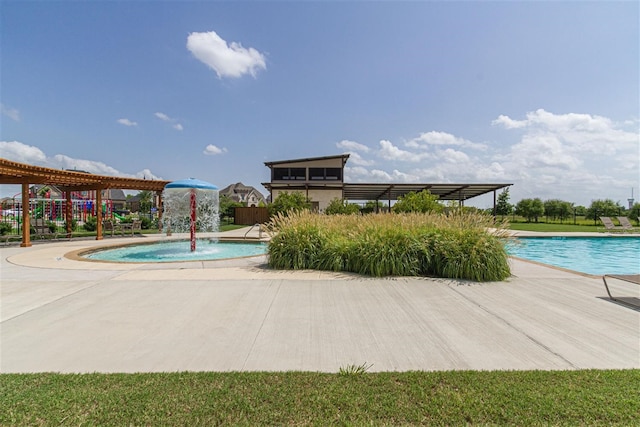 view of pool with a playground and pool water feature