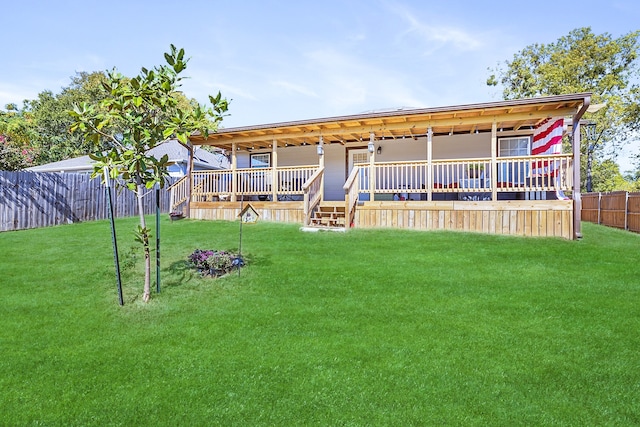 rear view of house featuring a yard